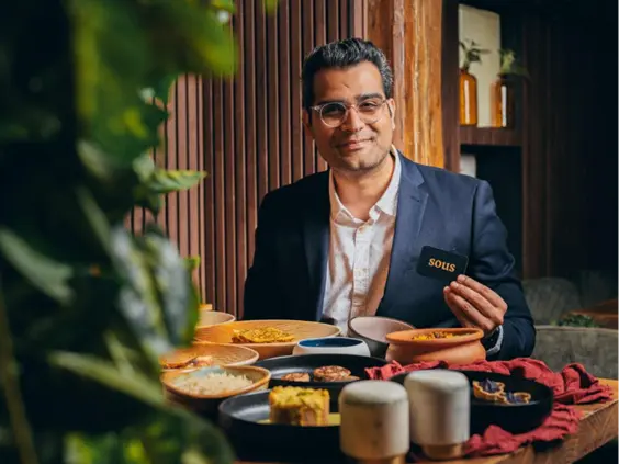 Abhi, BlendHouse’s owner, holding the sous app card, promoting Indian food delivery in Utrecht.